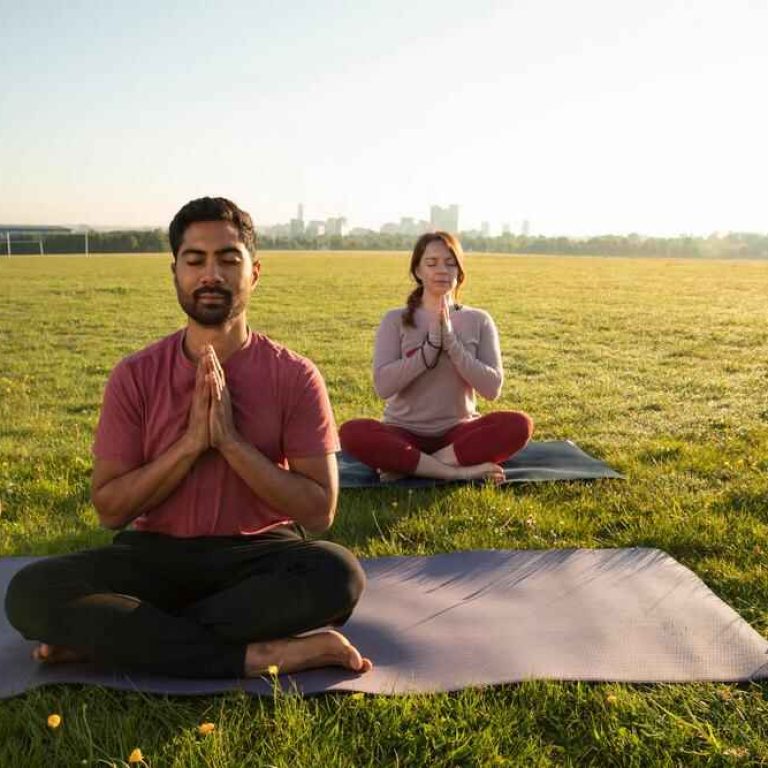 front-view-man-woman-meditating-outdoors-yoga-mats-2